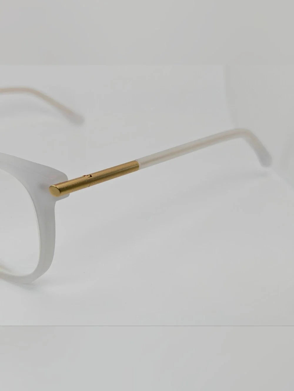 Cylinder. Women's Frosted White Round Frame Glasses. Cylinder Gold Highlights.